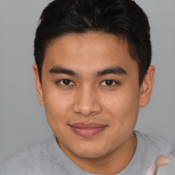 Joyful latino young-adult male with short  brown hair and brown eyes