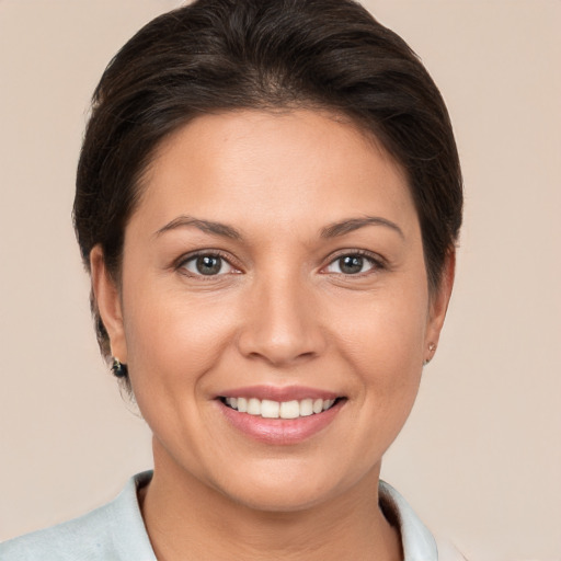 Joyful white young-adult female with short  brown hair and brown eyes