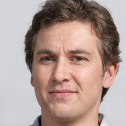 Joyful white adult male with short  brown hair and grey eyes