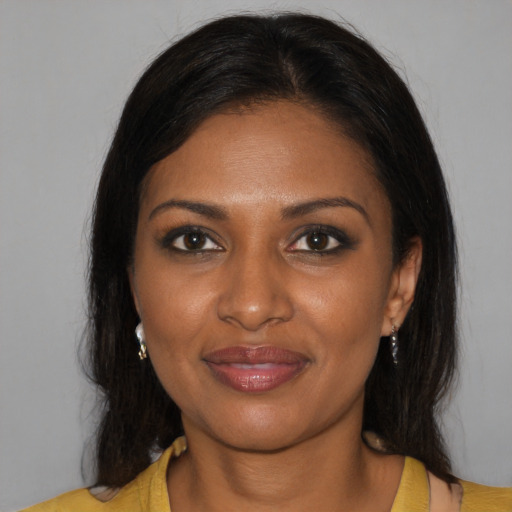Joyful black young-adult female with medium  brown hair and brown eyes
