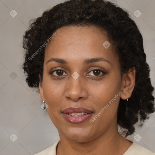 Joyful black adult female with medium  brown hair and brown eyes