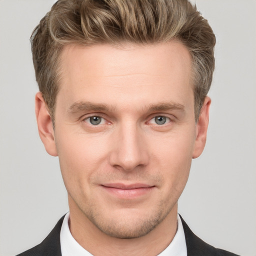 Joyful white young-adult male with short  brown hair and grey eyes