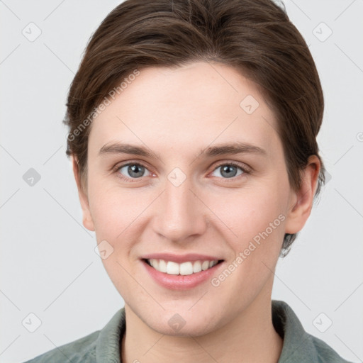 Joyful white young-adult female with short  brown hair and grey eyes