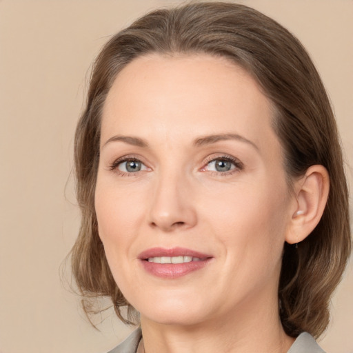 Joyful white adult female with medium  brown hair and brown eyes