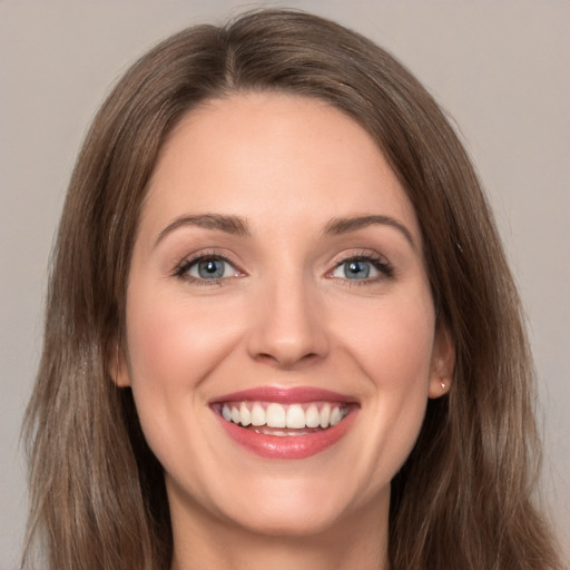 Joyful white young-adult female with long  brown hair and grey eyes