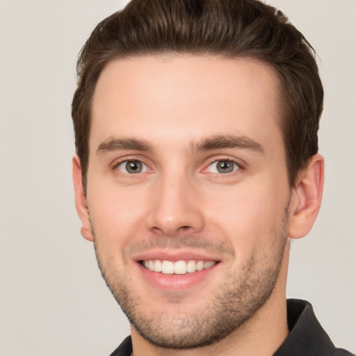 Joyful white young-adult male with short  brown hair and brown eyes