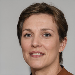 Joyful white adult female with medium  brown hair and grey eyes