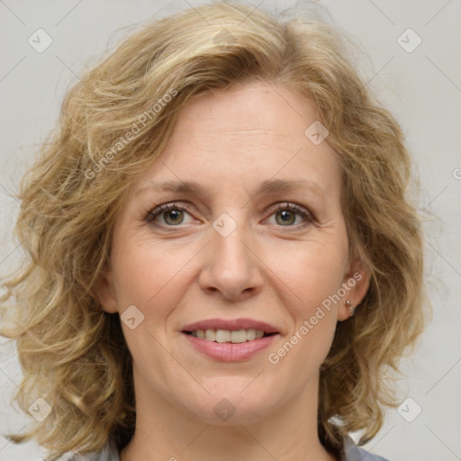 Joyful white adult female with medium  brown hair and blue eyes