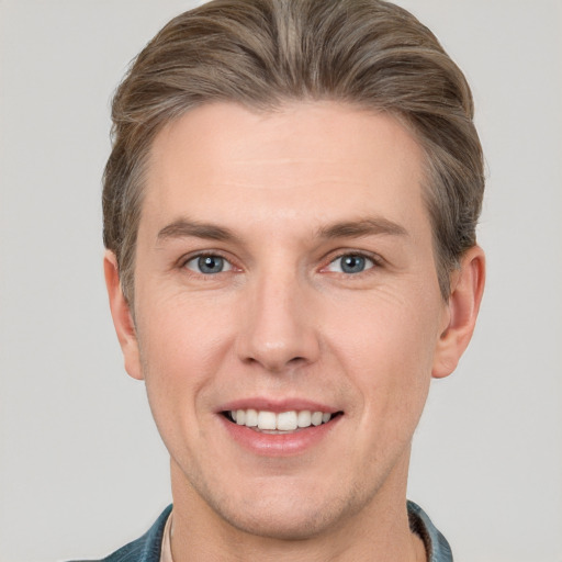 Joyful white adult male with short  brown hair and brown eyes