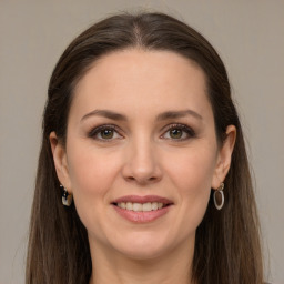 Joyful white young-adult female with long  brown hair and grey eyes