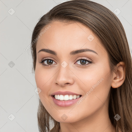 Joyful white young-adult female with long  brown hair and brown eyes