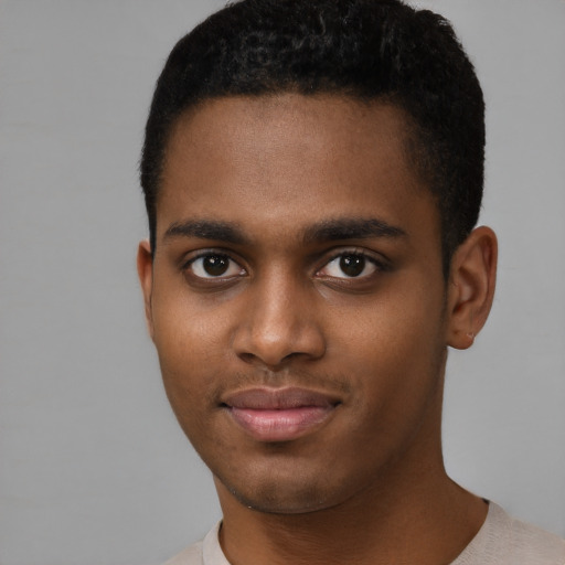 Joyful black young-adult male with short  brown hair and brown eyes