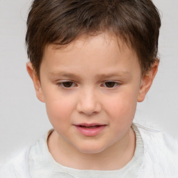 Joyful white child male with short  brown hair and brown eyes