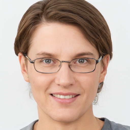 Joyful white adult female with short  brown hair and grey eyes