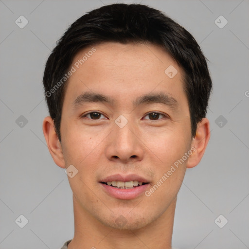 Joyful asian young-adult male with short  black hair and brown eyes