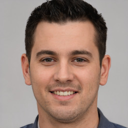 Joyful white young-adult male with short  brown hair and brown eyes