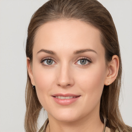 Joyful white young-adult female with long  brown hair and grey eyes