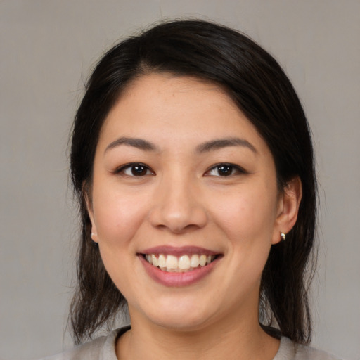 Joyful white young-adult female with medium  brown hair and brown eyes