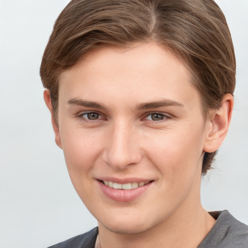 Joyful white young-adult female with short  brown hair and grey eyes