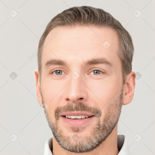 Joyful white young-adult male with short  brown hair and brown eyes