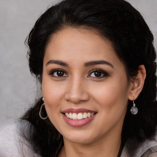 Joyful white young-adult female with long  black hair and brown eyes