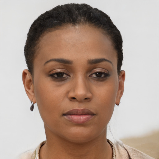 Joyful black young-adult female with short  brown hair and brown eyes