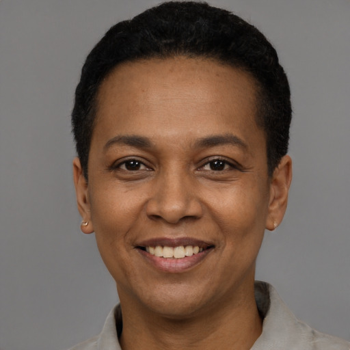 Joyful black adult female with short  black hair and brown eyes