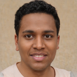 Joyful latino young-adult male with short  brown hair and brown eyes