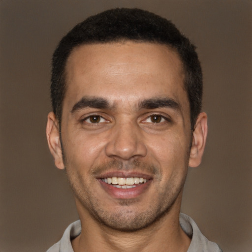 Joyful white young-adult male with short  black hair and brown eyes