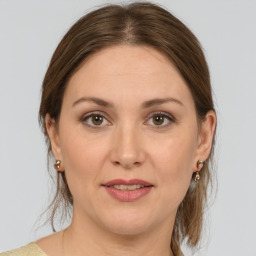 Joyful white adult female with medium  brown hair and brown eyes