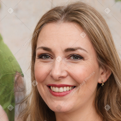 Joyful white adult female with long  brown hair and brown eyes