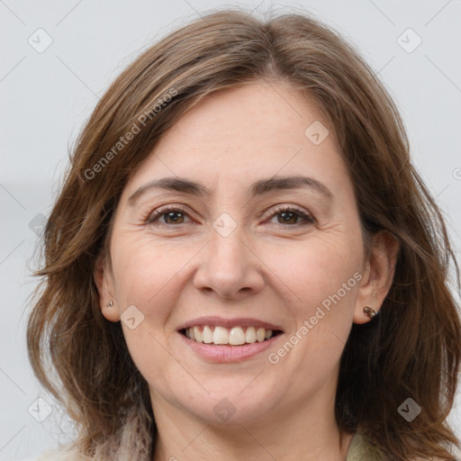 Joyful white adult female with long  brown hair and grey eyes