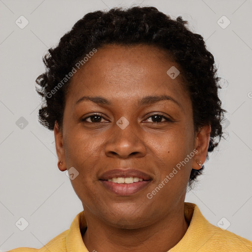 Joyful black adult female with short  brown hair and brown eyes