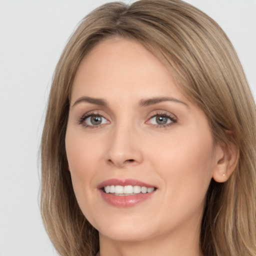 Joyful white young-adult female with long  brown hair and brown eyes