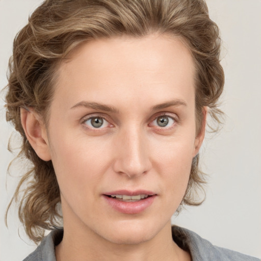 Joyful white young-adult female with medium  brown hair and blue eyes