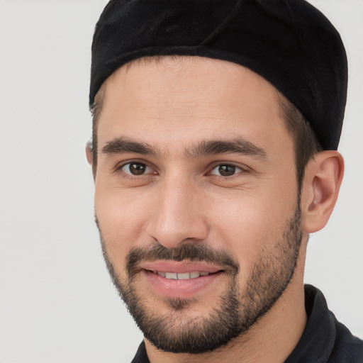 Joyful white young-adult male with short  black hair and brown eyes