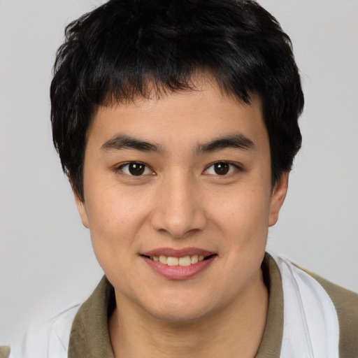 Joyful white young-adult male with short  black hair and brown eyes