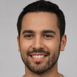 Joyful white young-adult male with short  black hair and brown eyes