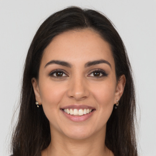 Joyful white young-adult female with long  brown hair and brown eyes