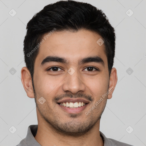 Joyful latino young-adult male with short  black hair and brown eyes