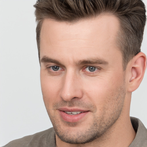 Joyful white adult male with short  brown hair and brown eyes