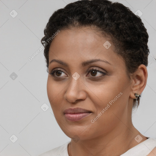 Joyful black young-adult female with short  brown hair and brown eyes