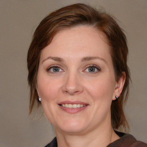 Joyful white adult female with medium  brown hair and blue eyes