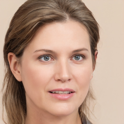 Joyful white young-adult female with long  brown hair and grey eyes