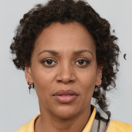 Joyful black adult female with short  brown hair and brown eyes