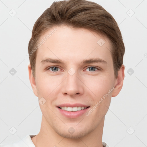 Joyful white young-adult male with short  brown hair and grey eyes