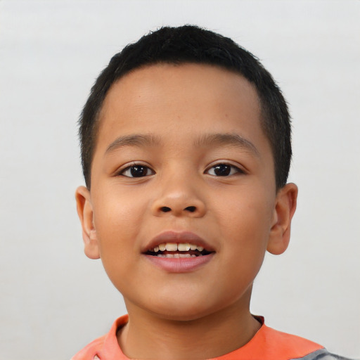 Joyful latino child male with short  brown hair and brown eyes