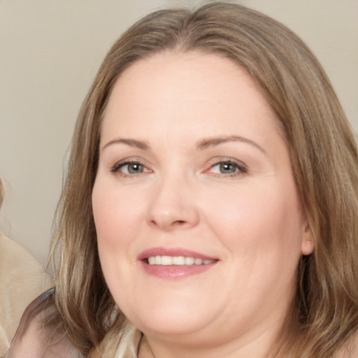 Joyful white adult female with long  brown hair and brown eyes