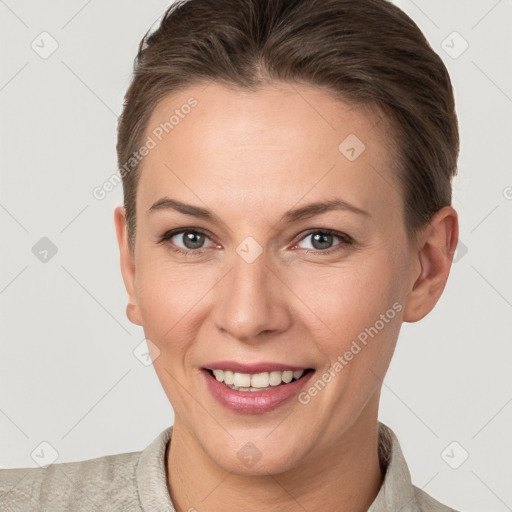 Joyful white young-adult female with short  brown hair and brown eyes