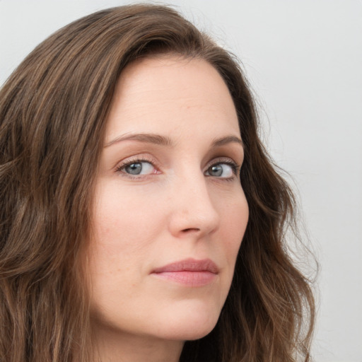 Neutral white young-adult female with long  brown hair and green eyes